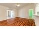 Bright living room featuring wood flooring and an open layout to adjoining rooms at 1927 Orange Tree Dr, Edgewater, FL 32141