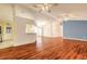 Open-concept living area with wood floors, a ceiling fan, and ample space for entertaining at 1927 Orange Tree Dr, Edgewater, FL 32141