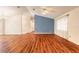 Spacious living area with wood floors, a ceiling fan, and plenty of natural light at 1927 Orange Tree Dr, Edgewater, FL 32141