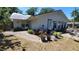Cozy patio next to the home and a beautifully landscaped backyard, perfect for outdoor enjoyment at 1927 Orange Tree Dr, Edgewater, FL 32141