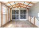 Unfinished shed interior with an open beam ceiling, peg board, and screened double doors at 1927 Orange Tree Dr, Edgewater, FL 32141