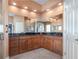 Well-lit bathroom with a double vanity, granite countertops, wood cabinets, and a large mirror at 202 Westcott Ct, Deland, FL 32724