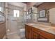 Bathroom with a glass-door shower, neutral color scheme, and a marble-top wood vanity at 202 Westcott Ct, Deland, FL 32724