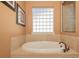 Bathroom showcasing a standalone bathtub with tile and a unique window for natural light at 202 Westcott Ct, Deland, FL 32724