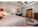 Comfortable bedroom featuring a ceiling fan, recessed ceilings, and stylish furniture with a view into the bathroom at 202 Westcott Ct, Deland, FL 32724