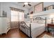 Bedroom featuring a full bed frame, wooden floors, and large windows at 202 Westcott Ct, Deland, FL 32724