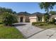 Beautiful single-story home featuring a brick driveway, lush landscaping, and a well-maintained lawn at 202 Westcott Ct, Deland, FL 32724