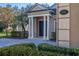 Inviting front entrance with classic white columns and a beautiful brick driveway in a landscaped yard at 202 Westcott Ct, Deland, FL 32724