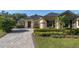 Charming home with a brick driveway, well-manicured landscaping, and a welcoming front entrance at 202 Westcott Ct, Deland, FL 32724
