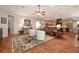 Open-concept living room featuring hardwood floors, tray ceilings, and seamless connection to the kitchen at 202 Westcott Ct, Deland, FL 32724