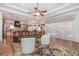 Spacious living room with wood floors, ceiling fan, and views of the kitchen at 202 Westcott Ct, Deland, FL 32724