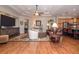 Spacious living room featuring wood floors, ceiling fan, with access to kitchen at 202 Westcott Ct, Deland, FL 32724