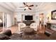 Bright living room with tray ceiling, hardwood floors, and cozy seating arrangement with a neutral color palette at 202 Westcott Ct, Deland, FL 32724