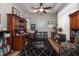 A home office with hardwood floors, a ceiling fan, and ample storage at 202 Westcott Ct, Deland, FL 32724
