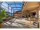 A large, screened patio with an outdoor seating area and comfortable bench at 202 Westcott Ct, Deland, FL 32724