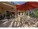 The covered patio has furniture and an outdoor umbrella with screening at 202 Westcott Ct, Deland, FL 32724