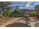 Spacious screened-in patio perfect for outdoor entertaining, featuring brick flooring and ample seating at 202 Westcott Ct, Deland, FL 32724