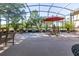 Spacious screened patio with brick flooring, outdoor seating, and views of lush landscaping at 202 Westcott Ct, Deland, FL 32724