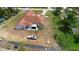 Overhead view of the house with a patio, yard, vehicle, and some greenery at 2048 Laredo Dr, Deltona, FL 32738