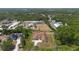 A sprawling property captured from above, showing the house amidst lush greenery and neighboring homes at 2048 Laredo Dr, Deltona, FL 32738