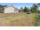Vast backyard with partial grass cover, featuring a view of the home's exterior and a parked truck at 2048 Laredo Dr, Deltona, FL 32738