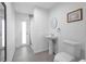 Bathroom featuring a toilet, single vanity, shower, and exterior door at 2048 Laredo Dr, Deltona, FL 32738