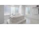 Bathroom featuring a soaking tub, tiled floors, and bright natural lighting at 2048 Laredo Dr, Deltona, FL 32738