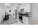 Bright kitchen features stainless steel appliances, granite countertops and white cabinetry at 2048 Laredo Dr, Deltona, FL 32738