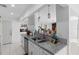 The kitchen features granite countertops, stainless steel sink, and white cabinets at 2048 Laredo Dr, Deltona, FL 32738