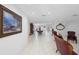 Open-concept living area featuring white tile flooring and a classic furniture set with neutral colors at 2048 Laredo Dr, Deltona, FL 32738