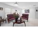 Bright living room features tile flooring and classic sofas, complemented by a decorative rug and an artistic touch at 2048 Laredo Dr, Deltona, FL 32738