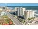 Aerial view of an oceanfront building featuring city views and close proximity to local shops at 2071 S Atlantic Ave # 705, Daytona Beach, FL 32118