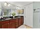 Spacious bathroom featuring a double vanity with dark wood cabinets and a large mirror at 2071 S Atlantic Ave # 705, Daytona Beach, FL 32118
