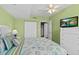 Bright bedroom with ceiling fan, large window, closet, and connecting door at 2071 S Atlantic Ave # 705, Daytona Beach, FL 32118