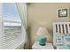 Bedroom with coastal decor, side table, turquoise lamp, and view through window with blinds at 2071 S Atlantic Ave # 705, Daytona Beach, FL 32118