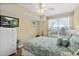 Cozy bedroom with large window and a dresser with a mounted television at 2071 S Atlantic Ave # 705, Daytona Beach, FL 32118