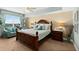 Bedroom featuring a decorative wood bed frame, a comfortable sitting area and ocean view at 2071 S Atlantic Ave # 705, Daytona Beach, FL 32118