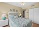Cozy bedroom with white furniture, seashell-themed bedding, carpet flooring, and a ceiling fan at 2071 S Atlantic Ave # 705, Daytona Beach, FL 32118