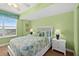 Bright bedroom with a queen bed, side tables and a window with blinds at 2071 S Atlantic Ave # 705, Daytona Beach, FL 32118