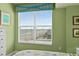 Bedroom with large window offering beach view, nautical decor and white dresser at 2071 S Atlantic Ave # 705, Daytona Beach, FL 32118