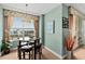 Bright dining area with a modern table set, complemented by a window with views of the city at 2071 S Atlantic Ave # 705, Daytona Beach, FL 32118
