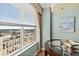 Bright dining area next to a large window with blinds showcasing views of the city and the ocean at 2071 S Atlantic Ave # 705, Daytona Beach, FL 32118