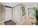 Welcoming condo entryway with tiled floors, coat closet, and accent decor at 2071 S Atlantic Ave # 705, Daytona Beach, FL 32118