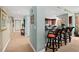 Hallway leading to an open kitchen with barstool seating, creating an inviting and connected living space at 2071 S Atlantic Ave # 705, Daytona Beach, FL 32118