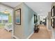 Hallway with carpet, neutral walls, and painting of a bedroom with a large bed at 2071 S Atlantic Ave # 705, Daytona Beach, FL 32118