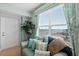 Window view of a beach, a plant, and a sofa with many decorative pillows at 2071 S Atlantic Ave # 705, Daytona Beach, FL 32118