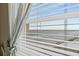 Window view of a white beach with a building complex and white blinds at 2071 S Atlantic Ave # 705, Daytona Beach, FL 32118