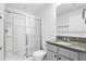 Bright bathroom with a walk-in shower, granite countertop, and ample vanity storage at 223 Courtland Blvd, Deltona, FL 32738
