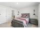 Cozy bedroom with neutral decor, accent wall sconces, and ensuite bathroom at 223 Courtland Blvd, Deltona, FL 32738