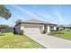 Single-story home with a clean design, spacious driveway, and well-kept front yard at 223 Courtland Blvd, Deltona, FL 32738